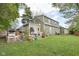 Spacious backyard view with mature trees, green grass, and the home's exterior at 6210 Mckinley Ct, Indianapolis, IN 46220