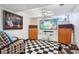 Comfortable entertainment space featuring checkerboard flooring and a large TV at 6210 Mckinley Ct, Indianapolis, IN 46220