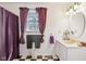 Bright bathroom with a sink vanity, oval mirror, decorative accents, and a classic black and white floor at 6210 Mckinley Ct, Indianapolis, IN 46220
