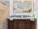 A bathroom with dual sinks, granite countertop, decorative lighting, and a large mirror at 6210 Mckinley Ct, Indianapolis, IN 46220