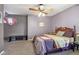 Bedroom with a ceiling fan and a purple accent wall, creating a cozy atmosphere at 6210 Mckinley Ct, Indianapolis, IN 46220