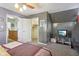 Comfortable bedroom featuring a ceiling fan, TV, closet, and doorway leading to the hallway at 6210 Mckinley Ct, Indianapolis, IN 46220