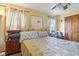 Comfortable bedroom with ceiling fan, stylish furniture, and natural light from a window at 6210 Mckinley Ct, Indianapolis, IN 46220