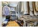 Well-organized walk-in closet with shelving, hanging rods, shoes, and hardwood floors at 6210 Mckinley Ct, Indianapolis, IN 46220