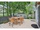 Outdoor deck with a dining set, surrounding green trees, and access to a screened-in porch at 6210 Mckinley Ct, Indianapolis, IN 46220