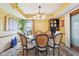 Bright dining room with stylish chandelier, round table, and unique wicker-backed chairs, perfect for entertaining at 6210 Mckinley Ct, Indianapolis, IN 46220