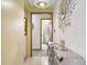 Stylish entryway with tiled floor, decorative mirror and console table, leading to bathroom and other rooms at 6210 Mckinley Ct, Indianapolis, IN 46220