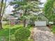 Picturesque home with mature trees and landscaping, offering curb appeal and a welcoming entrance at 6210 Mckinley Ct, Indianapolis, IN 46220