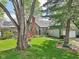 Beautiful home with lush landscaping, mature trees, and a welcoming front entrance, exuding curb appeal at 6210 Mckinley Ct, Indianapolis, IN 46220
