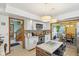 Bright kitchen with white cabinets, stainless appliances, and an open layout leading to dining room and staircase at 6210 Mckinley Ct, Indianapolis, IN 46220