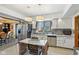 Well-lit kitchen with stainless steel appliances, white cabinets, and a cozy island with seating at 6210 Mckinley Ct, Indianapolis, IN 46220