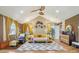 Spacious main bedroom featuring vaulted ceilings, chic decor, and a seating area at 6210 Mckinley Ct, Indianapolis, IN 46220