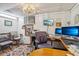 Office area with a chandelier, multiple monitors, work desks, and office chairs at 6210 Mckinley Ct, Indianapolis, IN 46220