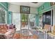 Cozy sun room with comfortable seating, glass table, and sliding doors to the outdoor deck at 6210 Mckinley Ct, Indianapolis, IN 46220