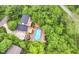 Stunning aerial view of a home with a pool surrounded by lush greenery and large deck at 6530 Lowanna Way, Indianapolis, IN 46220