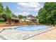 Beautiful backyard with a swimming pool, pool house, manicured landscaping, and multi-level decking at 6530 Lowanna Way, Indianapolis, IN 46220