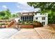 Well-maintained backyard with a large wooden deck, tiered landscaping, and a screened-in porch at 6530 Lowanna Way, Indianapolis, IN 46220