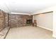 Unfinished basement featuring a red brick fireplace and neutral carpeting at 6530 Lowanna Way, Indianapolis, IN 46220
