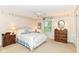 Bedroom with two windows, ceiling fan, dresser, and nightstand at 6530 Lowanna Way, Indianapolis, IN 46220
