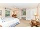 Bedroom with two windows, ceiling fan, dresser, closet, and sitting area at 6530 Lowanna Way, Indianapolis, IN 46220
