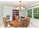 Traditional dining room with an elegant chandelier, wood table, and bright natural light at 6530 Lowanna Way, Indianapolis, IN 46220