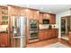 Well-equipped kitchen featuring stainless steel appliances and wood cabinets at 6530 Lowanna Way, Indianapolis, IN 46220
