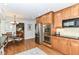 Eat-in kitchen featuring stainless steel appliances, wood cabinets, and granite countertops at 6530 Lowanna Way, Indianapolis, IN 46220