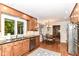Bright eat-in kitchen with wood cabinets, stainless appliances, and a view of the back yard at 6530 Lowanna Way, Indianapolis, IN 46220