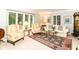Bright living room featuring large windows with plantation shutters and classic furniture at 6530 Lowanna Way, Indianapolis, IN 46220