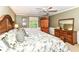 Large bedroom with detailed bedding, wood furniture, and a ceiling fan at 6530 Lowanna Way, Indianapolis, IN 46220