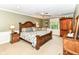 Spacious bedroom with wood furniture, neutral walls, and a ceiling fan at 6530 Lowanna Way, Indianapolis, IN 46220