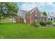 Back view of brick home with a well-manicured lawn and partial fence at 6789 Passage Cir, Indianapolis, IN 46250