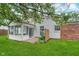 Backyard featuring a well-maintained lawn, brick patio, and siding with a sunroom at 6789 Passage Cir, Indianapolis, IN 46250