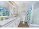 Bathroom featuring double sinks, tile floors, and a shower with vibrant curtains at 6789 Passage Cir, Indianapolis, IN 46250