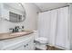 Bathroom featuring a vanity with a stone countertop and a shower with a white shower curtain at 6789 Passage Cir, Indianapolis, IN 46250