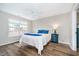 Bedroom featuring a ceiling fan, wood-look floors, and bright natural light from the window at 6789 Passage Cir, Indianapolis, IN 46250