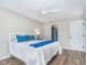 Bedroom features a ceiling fan, wood-look floors, and bright natural light from the window at 6789 Passage Cir, Indianapolis, IN 46250