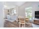Eat-in kitchen features a window view, breakfast table, white cabinets, and wood-look floors at 6789 Passage Cir, Indianapolis, IN 46250