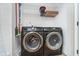 Laundry room showcases front-load washer and dryer, complemented by wire shelving for organized storage at 6789 Passage Cir, Indianapolis, IN 46250