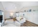 Bright living room featuring a vaulted ceiling, white couch, stylish decor, and wood-look floors at 6789 Passage Cir, Indianapolis, IN 46250