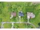 Bird's eye view of home showcasing well-manicured lawn, mature trees, and neighborhood streets at 679 Bark Dr, Anderson, IN 46011