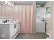 Updated bathroom with integrated sink and stacked washer and dryer at 679 Bark Dr, Anderson, IN 46011