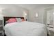 Well-lit bedroom with a queen bed, gray walls, and an en-suite bathroom, enhancing convenience at 679 Bark Dr, Anderson, IN 46011