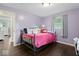 Cozy bedroom featuring pastel-painted walls, hardwood floors and natural light from a side window at 679 Bark Dr, Anderson, IN 46011