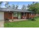 Close-up of the home's exterior, showing the red brick, updated windows, and front porch at 679 Bark Dr, Anderson, IN 46011
