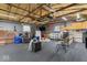Finished garage with bar seating area, an American flag, and large interior space at 679 Bark Dr, Anderson, IN 46011