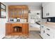 Kitchen detail with built-in wooden cabinets and view to connected living space at 679 Bark Dr, Anderson, IN 46011