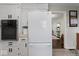 Kitchen featuring white appliances and view of connected living spaces at 679 Bark Dr, Anderson, IN 46011