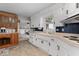 Bright kitchen with white cabinetry, contrasting hardware, and open view to the living space at 679 Bark Dr, Anderson, IN 46011