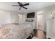 Comfortable main bedroom with TV and view to en-suite bath with privacy curtain at 679 Bark Dr, Anderson, IN 46011